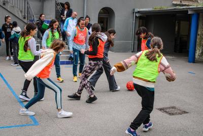 Des collégiennes engagées dans une partie de football dynamique, sous le regard attentif des joueuses de l'Olympique de Marseille, favorisant l'échange et la transmission des valeurs du sport. - Agrandir l'image 2 sur 16, fenêtre modale