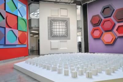 une salle avec des effets visuels au mur, des formes comme des losange des octogones ect et des pieces de plusieurs formes, blanche, au sol - Agrandir l'image 9 sur 9, fenêtre modale